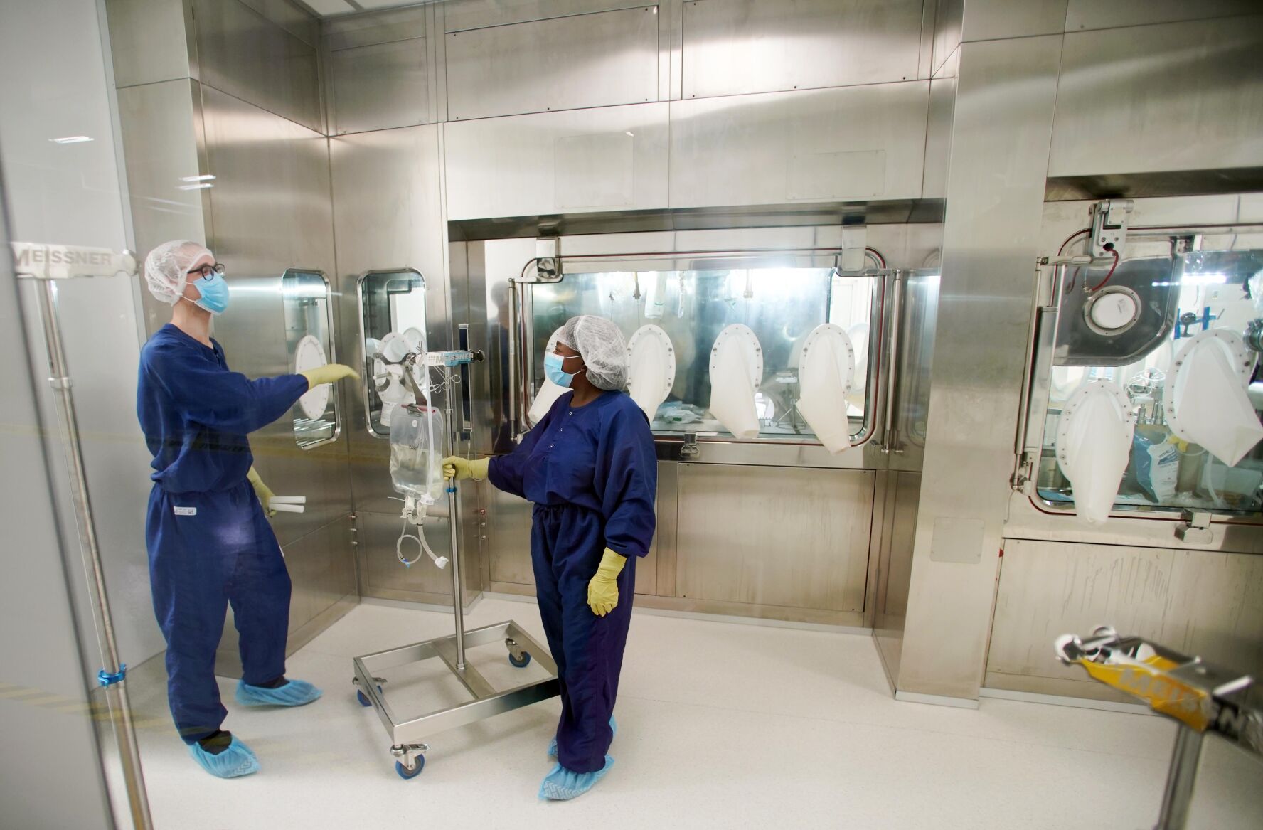 Workers wearing masks using equipment
